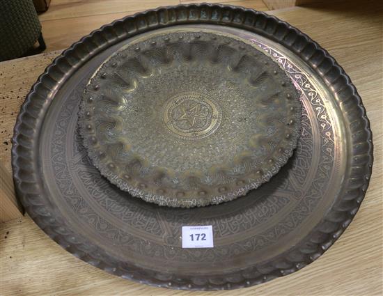 Three Islamic brass dishes, Largest W.55cm